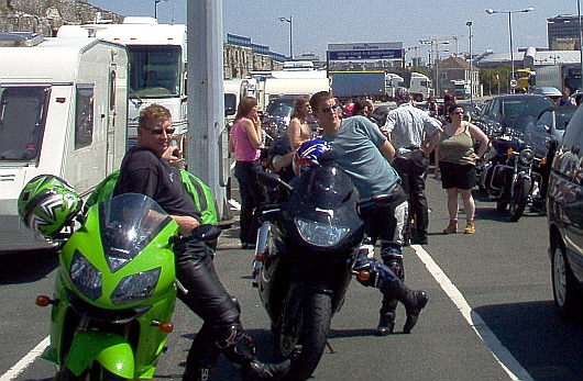 Bikers, bikes, cars, caravans and camper vans all waiting to board the ferry